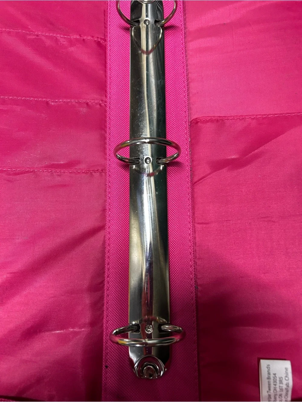Hot pink, 3 ring binder notebook that zips up and has sequins on the front.